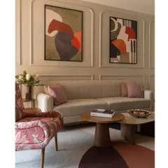 A closer look at the living area, where a floral accent chair and a multi-toned rug add layers of color and pattern to the neutral base.