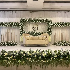 For a classic and elegant look, I design stunning engagement stages like this one. The lush white floral arrangement, combined with soft lighting and a beautiful monogram, creates a sophisticated backdrop for your celebration.