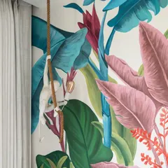 'The Whispering Palms' mural was designed to bring a playful, tropical jungle into a child's room. The hand-painted scene is filled with lush, colorful foliage and a whimsical monkey, creating a joyful and imaginative backdrop for play and dreams.