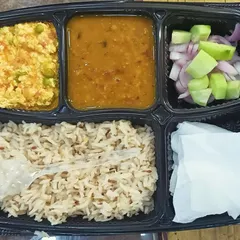 A healthy meal option with paneer bhurji, dal, and brown rice. It's a balanced meal that is high in protein and fiber, perfect for a nutritious lunch.