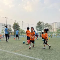 Young players navigate a cone drill during a training session. Our drills for this age group are designed as fun games to develop basic motor skills.