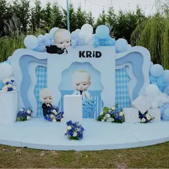 Who's the boss? This "Boss Baby" themed party setup features a multi-layered backdrop in shades of blue and white, complete with character cutouts and a cloud of balloons, perfect for a cool little dude's birthday.