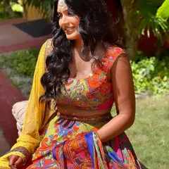 Our client looking joyful in her colorful lehenga, with her look completed by our classic Kundan maang tikka. It's the perfect accessory for a traditional yet vibrant Mehendi or Sangeet.