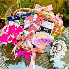 I was thrilled to create this custom birthday hamper for Indian cricketer Bhuvneshwar Kumar. This wicker basket is filled with a curated selection of gourmet treats, including dark chocolate, savory nuts, and other favorites, all elegantly wrapped with pink and lilac ribbons.