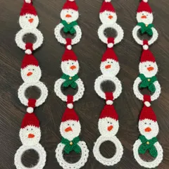 A set of my handmade snowman hangings, ready to adorn a Christmas tree or be used as festive decor around the house. Each one has a little Santa hat and a green scarf.