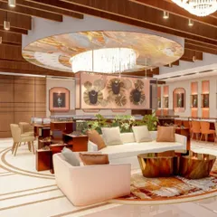 A vibrant and contemporary lounge area within the Batukbhai Jewellers showroom. We used a custom-printed ceiling feature, artistic furniture, and warm metallic accents to create a dynamic and welcoming space for client consultations.