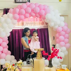 Holding my daughter Aarya in front of her birthday decorations. She is my little Aaru puti.