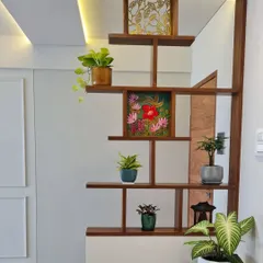 This indoor plant shelf doubles as an elegant room divider. It separates the space while allowing natural light to pass through, with each shelf styled with a unique plant or art piece.