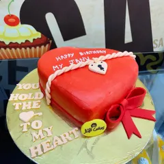 A vibrant red, heart-shaped fondant cake perfect for expressing love on a birthday, anniversary, or Valentine's Day. The intricate rope and lock details add a personalized touch.