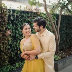 Wrapped in a quiet embrace, this is the gentle start to a lifelong journey. This pre-wedding portrait captures the couple's connection against a lush, natural backdrop.