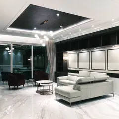 This is what happens when modern luxury meets a cozy night in. We designed this living room with a dramatic dark ceiling, marble floors, and plush seating to create a space that’s perfect for hosting or just chilling. It’s high-end without being stuffy.
