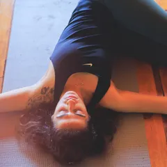 A moment of deep rest in a supine spinal twist. Restorative yoga isn't about stretching, but about releasing and allowing the body to be held.
