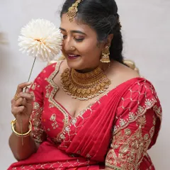 The joy of dressing up for a special occasion. Our client looks beautiful in this red embroidered lehenga, perfect for making memories.