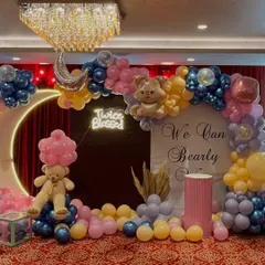A complete view of our "We Can Bearly Wait" baby shower theme. This setup includes a large illuminated moon, a custom backdrop, a "Twice Blessed" neon sign, and an elaborate balloon arch, creating a magical atmosphere for the celebration.