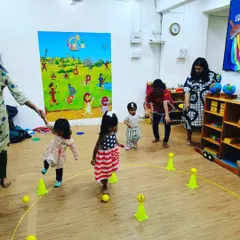 This is a typical scene from one of my indoor sessions. We use colorful cones and soft balls to create exciting obstacle courses and games. It’s organized chaos that helps children improve their agility, coordination, and ability to follow instructions.