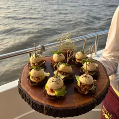 Your celebration, your location. We bring the complete gourmet experience wherever you are, even sailing into the sunset on a yacht. This event featured custom bite-sized sliders, perfect for enjoying the sea breeze and stunning Mumbai views.