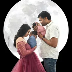 A family portrait under the moon. The proud parents hold their twin newborns, creating a magical and unforgettable first family photo.