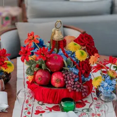 A vibrant centerpiece of pomegranates and colorful flowers from a wedding in Turkey. We love incorporating local and seasonal elements into our decor to create an authentic and culturally rich atmosphere.