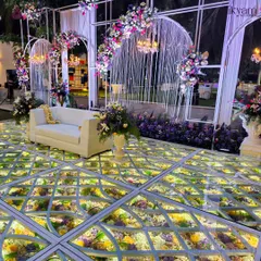 A side angle of the illuminated floral floor, highlighting how it creates a magical glow and enhances the overall ambiance of the reception venue.