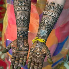 A perfect example of symmetrical bridal mehendi, where both hands mirror each other beautifully. This design features classic bride and groom portraits, intricate peacocks, and traditional architectural motifs for a timeless look.