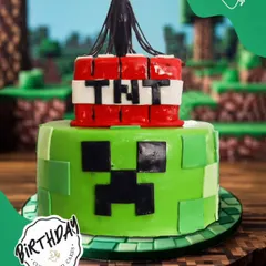 An explosive Minecraft TNT cake. This two-tier design features a Creeper face and a TNT block on top, ready to make the birthday a total blast.