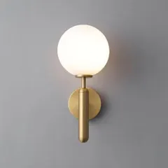 This product shot showcases the warm, even glow produced by the frosted globe sconce. The light is soft and flattering, ideal for creating ambient lighting in living rooms or bedrooms.