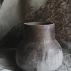 I call this pit-fired piece 'Stardust'. The subtle, speckled effect was created by throwing sawdust onto the hot surface of the vase during the firing. It’s earthy, subtle, and beautiful.