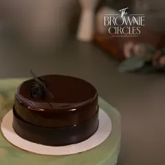 The Chocolate Truffle bento cake, finished with a mirror glaze. Its sleek, simple design makes it a sophisticated choice for any small occasion.