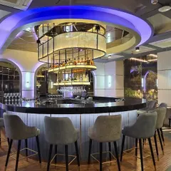 The central bar at the Novotel in Guwahati, designed to be the heart of the hotel's social space. We used a combination of ambient and feature lighting, including a custom-designed circular chandelier, to create a sophisticated and welcoming atmosphere for guests.