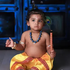 We celebrate culture and tradition with our special themed photoshoots. This adorable 'Little Krishna' session for Janmashtami uses authentic costumes and props to create a divine and heartwarming portrait of your child.