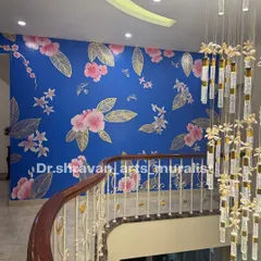 A stunning double-height staircase wall featuring gold foil and pink florals against a vibrant blue background. The scale of the work makes a huge impact in this grand home.