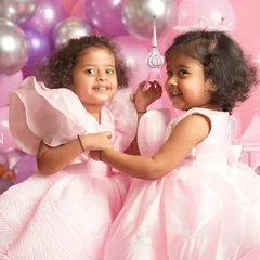 A sweet moment of connection between two sisters during their princess-themed photoshoot. These are the unscripted interactions that I love to capture, showing their genuine bond.