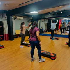 A view from the back of the class, showing everyone in sync. The large mirror helps you check your form and stay aligned with the group.