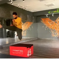 A student practices a flying side kick over a plyosoft box. Drills like these are not just about technique; they build courage and a belief in their own abilities.