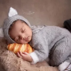 A tiny baker napping on a croissant pillow. This setup is perfect for food-loving families and adds a touch of Parisian charm to your newborn's gallery.