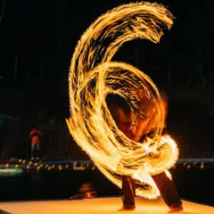 Our festivals are more than just climbing. As night falls, the energy transforms with incredible performances like this fire poi show, lighting up the sky over the water and creating a truly magical atmosphere for everyone.