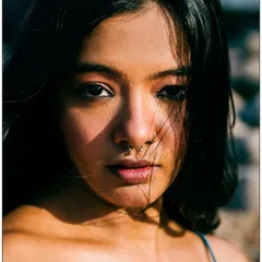 An intense, close-up portrait using the harsh midday sun. I positioned the model so the light creates a dramatic shadow across her face, adding depth and a bit of edge to the shot. The stray hairs blowing in the wind add to the raw, natural feel.