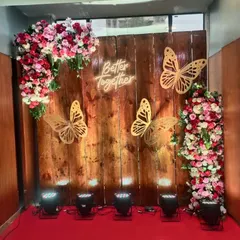 A popular selfie point design with a rustic wooden backdrop. It's adorned with floral arrangements and a "Better Together" neon sign, creating a perfect spot for guest photos.