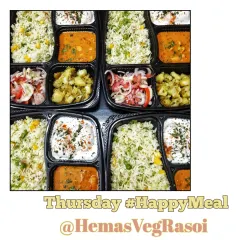 A colourful array of Thursday Happy Meals ready for delivery. This meal included Corn Mutter Pulav, rich Kaju Masala, simple Jeera Aloo, refreshing Salad, and soft Dahi Wadas.
