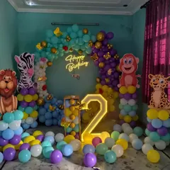 I can bring any theme to life, like this vibrant jungle-themed party for a second birthday. The setup includes a full balloon ring, large cutouts of jungle animals like a lion, zebra, and monkey, and a light-up marquee number.