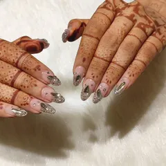 Every detail matters on your wedding day. This angle shows how the custom stone and glitter nail art complements the traditional henna, creating a cohesive and stunning bridal look.