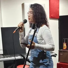 A shot from an open mic night. Performing live, even in a small setting, is a great way to connect with an audience and share the music directly.