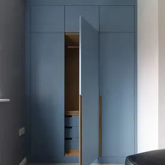 This view shows one door open, revealing the hanging rail and internal drawers, demonstrating the practical storage solutions we build.