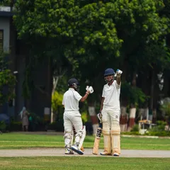 A moment of celebration between two batsmen after a successful partnership. I encourage my players to acknowledge each other's contributions and play as a cohesive unit.