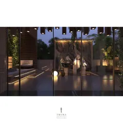 A view from inside looking out onto the terrace at dusk. The strategic lighting, both indoors and outdoors, creates a magical atmosphere and highlights the seamless connection between the two spaces.