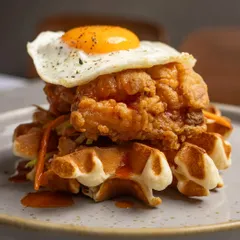 The irresistible stack of crispy fried chicken and fluffy waffles, a signature savory dish on our Sunday brunch menu.