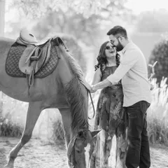 Laughter and love in a timeless black and white frame. Sharing a candid moment with a gentle friend, this shot captures the playful and tender side of their relationship during their pre-wedding session.