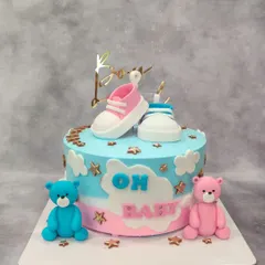 "Twinkle, twinkle, little star, how we wonder what you are." This gender reveal cake features pink and blue bears and tiny baby shoes, perfect for a baby shower.