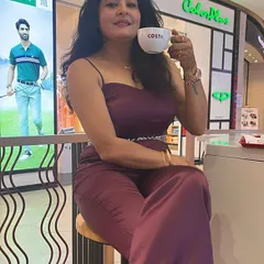 Attending a beauty event in a custom wine-colored satin jumpsuit with a hand-embroidered belt.