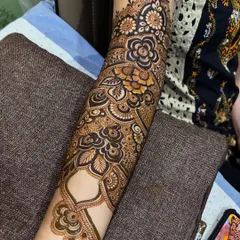 Here you can see how the floral cuff extends into a full-arm design, with paisleys and leafy vines creating a beautiful flow from the wrist to the elbow.